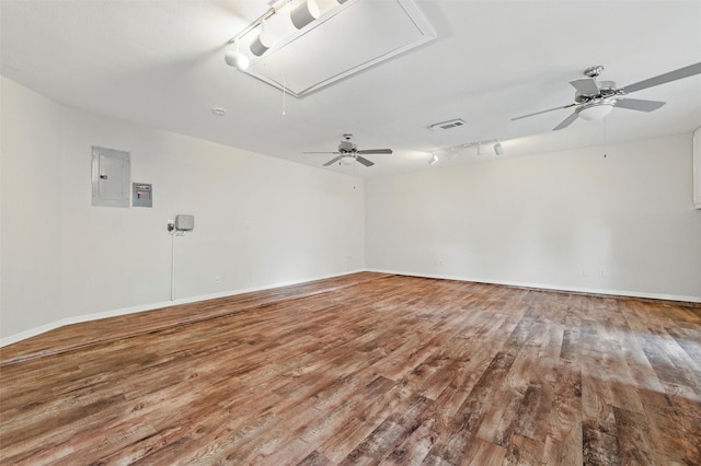 3402 Blue Forest Dr, Arlington, TX 76001 - unfurnished room featuring attic access, wood finished floors, track lighting, a ceiling fan, and electric panel