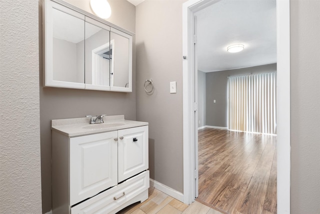 2363 Talco Dr, Dallas, TX 75241 - bathroom with wood finished floors, vanity, and baseboards