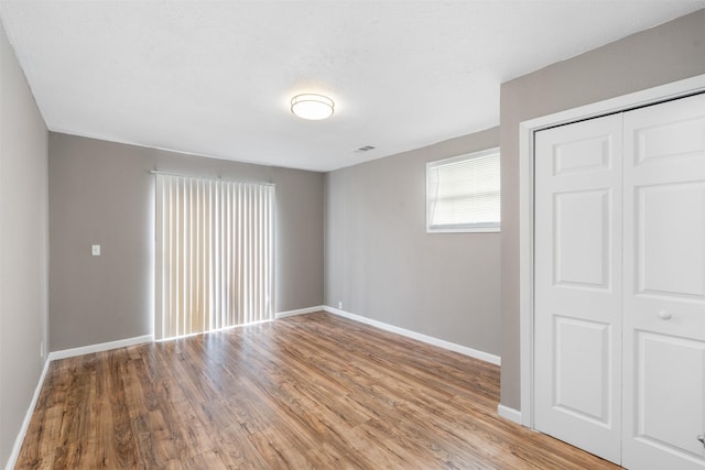 2363 Talco Dr, Dallas, TX 75241 - unfurnished bedroom with light wood finished floors, baseboards, and a closet