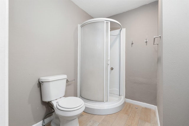 2363 Talco Dr, Dallas, TX 75241 - bathroom with wood finished floors, a shower stall, toilet, and baseboards