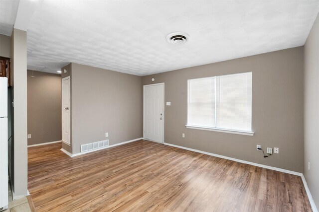 2363 Talco Dr, Dallas, TX 75241 - unfurnished room featuring light wood finished floors, baseboards, and attic access