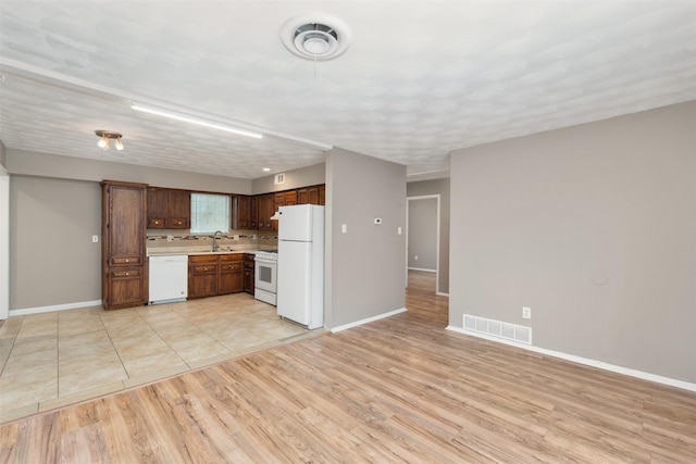 2363 Talco Dr, Dallas, TX 75241 - kitchen featuring white appliances, light countertops, baseboards, and a sink