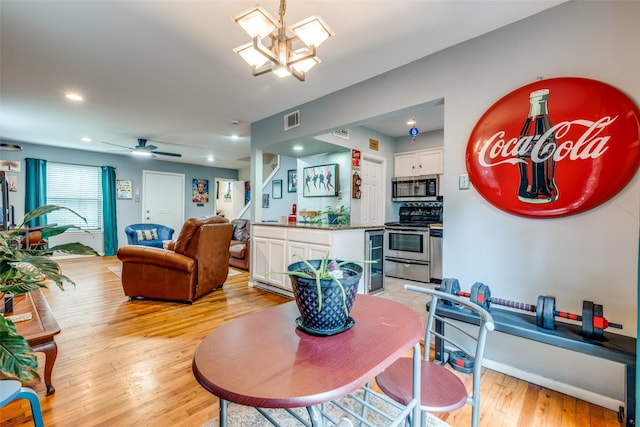 4902 N Hall St, Dallas, TX 75235 - dining area featuring light wood finished floors, a chandelier, beverage cooler, recessed lighting, and a ceiling fan
