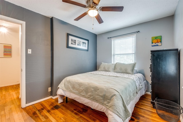4902 N Hall St, Dallas, TX 75235 - bedroom featuring wood finished floors, baseboards, and a ceiling fan