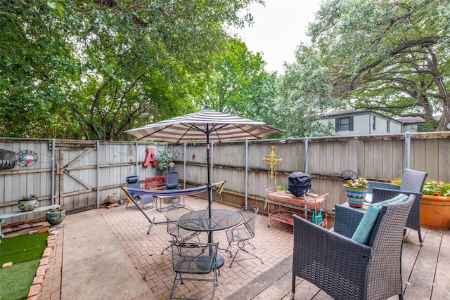 4902 N Hall St, Dallas, TX 75235 - fenced backyard featuring outdoor dining area, a patio area, and a gate