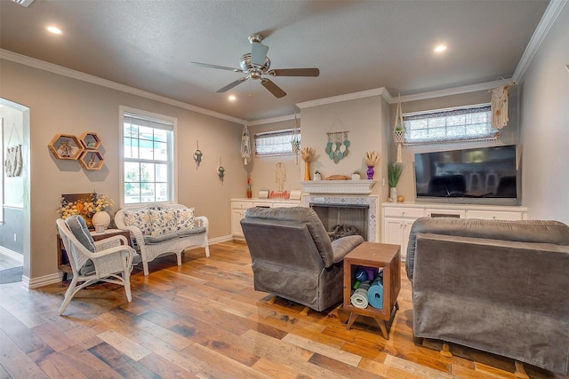 106 Camelot St, Glen Rose, TX 76043 - living room with ceiling fan, light wood finished floors, crown molding, recessed lighting, and a fireplace