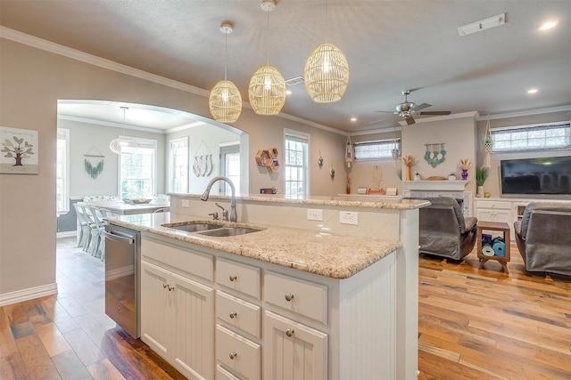 106 Camelot St, Glen Rose, TX 76043 - kitchen with ceiling fan, arched walkways, open floor plan, light wood finished floors, and crown molding