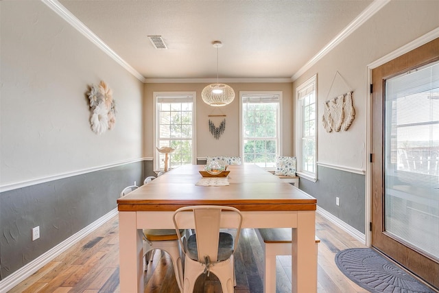 106 Camelot St, Glen Rose, TX 76043 - dining space featuring light wood finished floors and crown molding