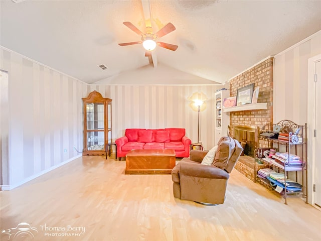 2850 Button Willow Ave, Abilene, TX 79606 - living area with lofted ceiling, a ceiling fan, wood finished floors, wallpapered walls, and a fireplace
