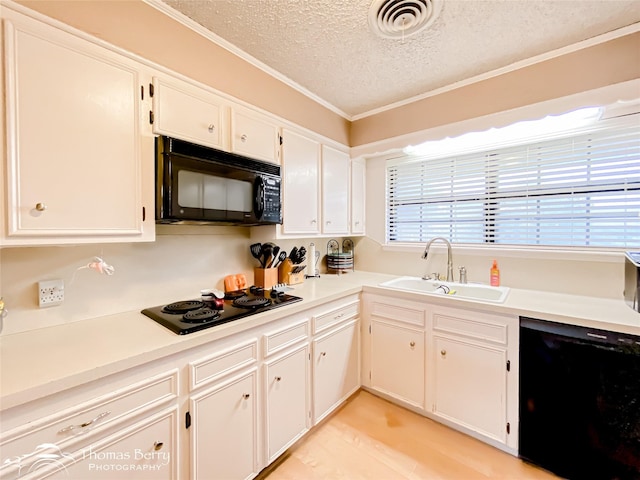 2850 Button Willow Ave, Abilene, TX 79606 - kitchen featuring black appliances, a sink, a textured ceiling, ornamental molding, and white cabinets
