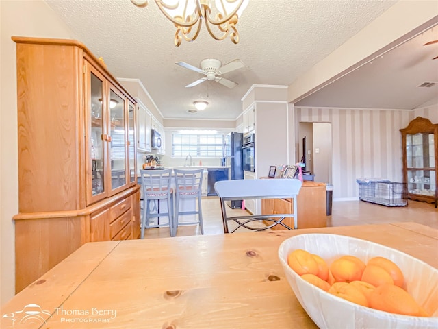 2850 Button Willow Ave, Abilene, TX 79606 - dining area featuring ceiling fan, a chandelier, and a textured ceiling