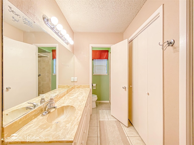 2850 Button Willow Ave, Abilene, TX 79606 - bathroom with toilet, vanity, tile patterned floors, a textured ceiling, and a shower