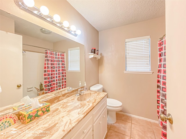 2850 Button Willow Ave, Abilene, TX 79606 - bathroom featuring toilet, vanity, a textured ceiling, tile patterned flooring, and a shower with curtain