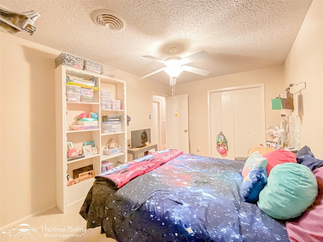 2850 Button Willow Ave, Abilene, TX 79606 - carpeted bedroom with a textured ceiling, a closet, and a ceiling fan