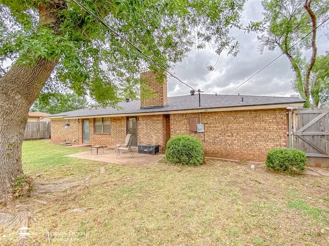2850 Button Willow Ave, Abilene, TX 79606 - back of house featuring brick siding, a chimney, a patio area, a gate, and roof with shingles