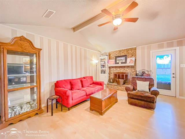 2850 Button Willow Ave, Abilene, TX 79606 - living area featuring a ceiling fan, a textured ceiling, a fireplace, and wallpapered walls