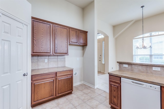 1728 Sandpiper Ln, Carrollton, TX 75007 - kitchen with white dishwasher, backsplash, arched walkways, and decorative light fixtures