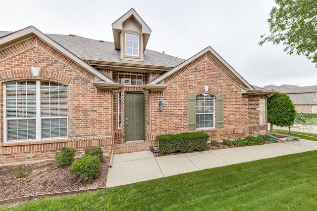 1728 Sandpiper Ln, Carrollton, TX 75007 - view of front of house with brick siding and a shingled roof