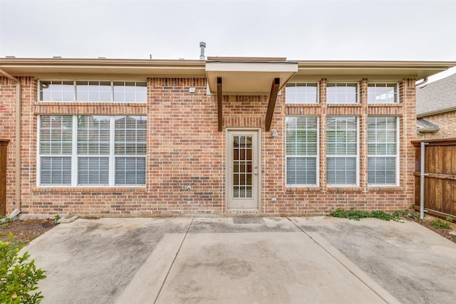 1728 Sandpiper Ln, Carrollton, TX 75007 - doorway to property with a patio area and brick siding