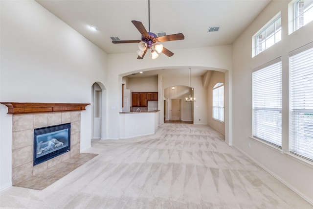 1728 Sandpiper Ln, Carrollton, TX 75007 - unfurnished living room featuring light carpet, ceiling fan, a fireplace, and healthy amount of natural light