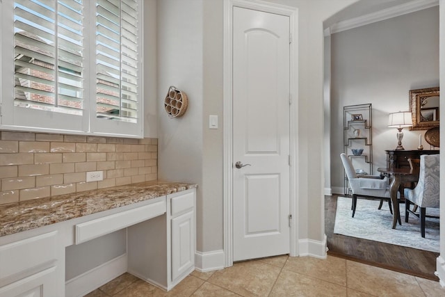 3500 Oak Island Ln, Flower Mound, TX 75028 - kitchen with tasteful backsplash, white cabinets, light stone countertops, light tile patterned flooring, and baseboards