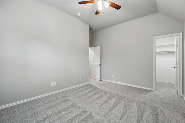3500 Oak Island Ln, Flower Mound, TX 75028 - unfurnished bedroom with carpet flooring, vaulted ceiling, a walk in closet, baseboards, and ceiling fan
