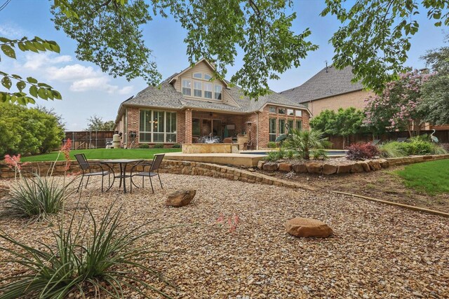 3500 Oak Island Ln, Flower Mound, TX 75028 - rear view of house with brick siding, a patio, and roof with shingles