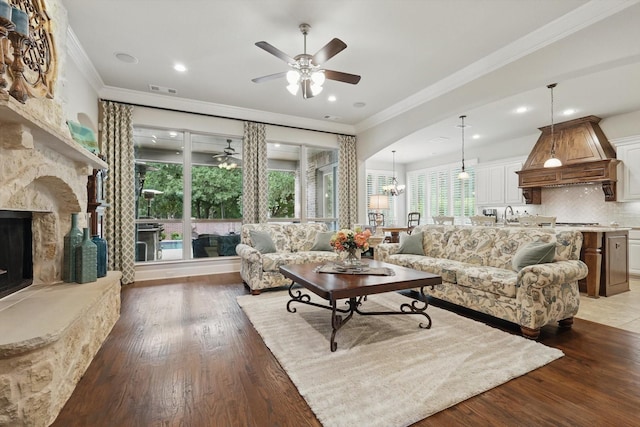 3500 Oak Island Ln, Flower Mound, TX 75028 - living room with a ceiling fan, a fireplace, crown molding, light wood-style floors, and recessed lighting