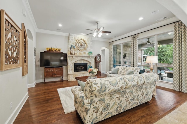 3500 Oak Island Ln, Flower Mound, TX 75028 - living area featuring arched walkways, ornamental molding, ceiling fan, dark wood-style floors, and a premium fireplace