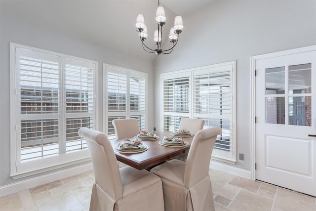 507 Clover Leaf Ln, Mckinney, TX 75072 - dining room featuring a chandelier, stone tile floors, baseboards, and lofted ceiling
