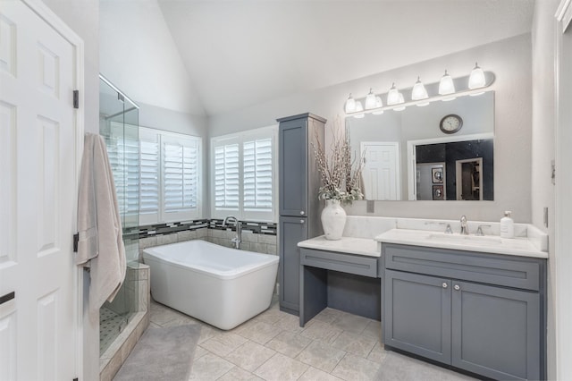 507 Clover Leaf Ln, Mckinney, TX 75072 - bathroom featuring vaulted ceiling, a soaking tub, a shower stall, and vanity