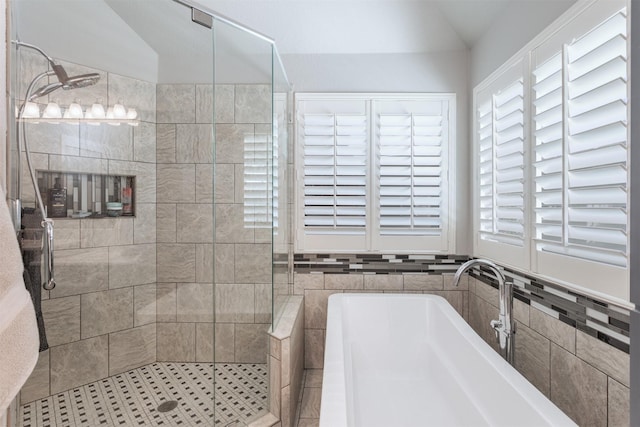 507 Clover Leaf Ln, Mckinney, TX 75072 - bathroom with vaulted ceiling, a bath, a shower stall, and tile walls