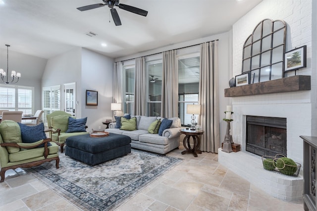 507 Clover Leaf Ln, Mckinney, TX 75072 - living room with a ceiling fan, a chandelier, a brick fireplace, stone tile floors, and high vaulted ceiling