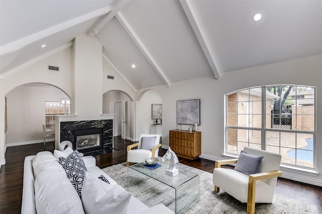 4605 Lafayette Ave, Fort Worth, TX 76107 - living area with arched walkways, beam ceiling, plenty of natural light, baseboards, and recessed lighting