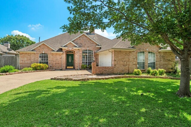 3310 Summergrove Dr, Arlington, TX 76001 - view of front of house with a garage, roof with shingles, brick siding, driveway, and a chimney