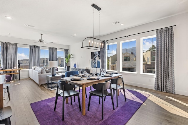 8120 Bromley Dr, Dallas, TX 75231 - dining space with light wood-type flooring, a ceiling fan, recessed lighting, baseboards, and a chandelier