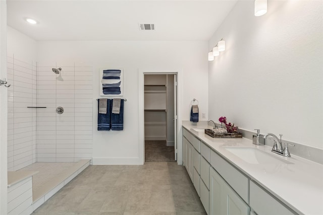 8120 Bromley Dr, Dallas, TX 75231 - full bathroom with walk in shower, double vanity, baseboards, and a walk in closet