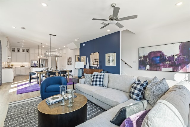 8120 Bromley Dr, Dallas, TX 75231 - living room with light wood finished floors, recessed lighting, and a ceiling fan