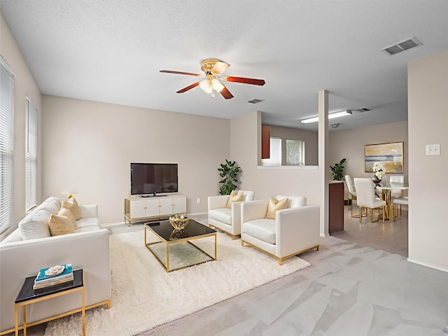 7605 Mosspoint Ct, Denton, TX 76210 - living area with a ceiling fan and baseboards