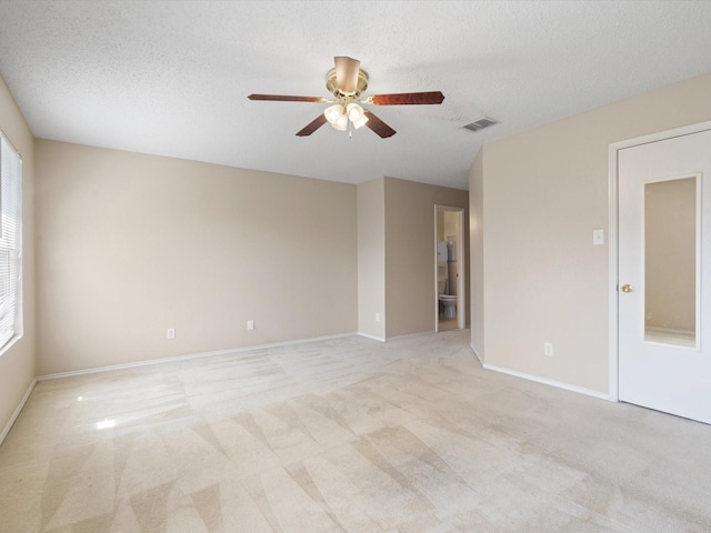 7605 Mosspoint Ct, Denton, TX 76210 - unfurnished room featuring ceiling fan, light colored carpet, a textured ceiling, and baseboards