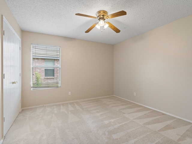 7605 Mosspoint Ct, Denton, TX 76210 - unfurnished room with light carpet, ceiling fan, a textured ceiling, and baseboards