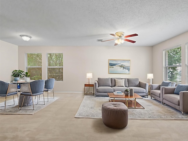 7605 Mosspoint Ct, Denton, TX 76210 - carpeted living room with a ceiling fan, a textured ceiling, and baseboards