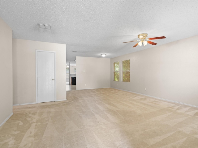 7605 Mosspoint Ct, Denton, TX 76210 - unfurnished room with ceiling fan, light carpet, baseboards, and a textured ceiling