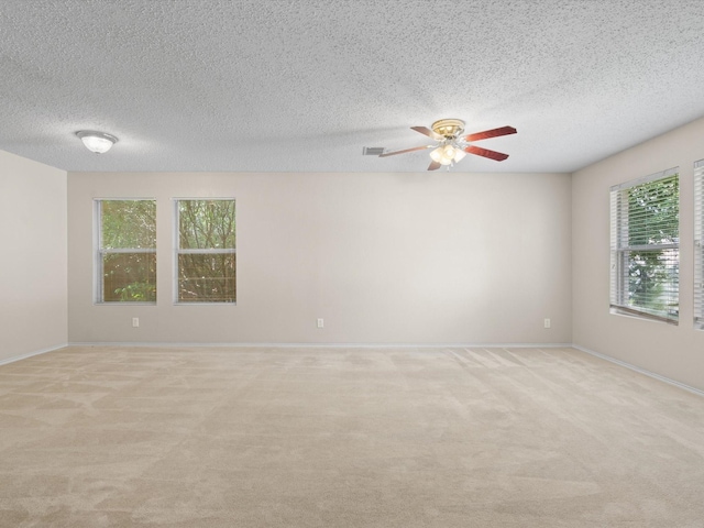 7605 Mosspoint Ct, Denton, TX 76210 - unfurnished room with a textured ceiling, light carpet, ceiling fan, and baseboards