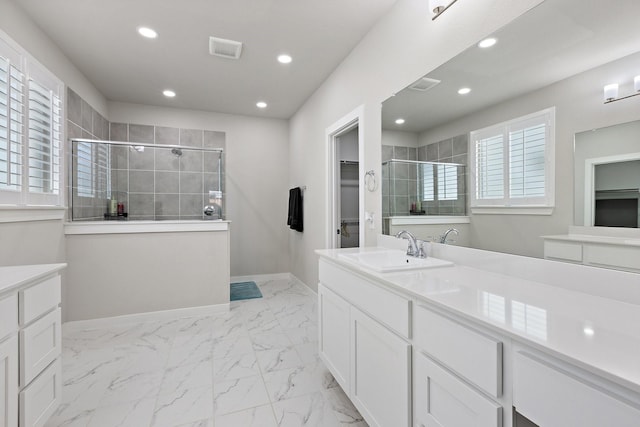 2012 Edgewater St, Celina, TX 75009 - full bathroom with a walk in closet, vanity, tiled shower, marble finish floors, and recessed lighting