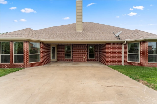 238 Rudder, Gun Barrel City, TX 75156 - rear view of property with a chimney, brick siding, roof with shingles, and a patio area
