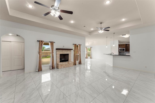 238 Rudder, Gun Barrel City, TX 75156 - unfurnished living room with a tray ceiling, ceiling fan, baseboards, arched walkways, and recessed lighting