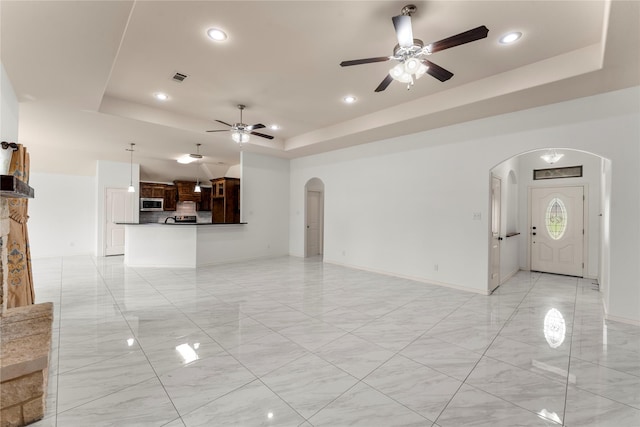 238 Rudder, Gun Barrel City, TX 75156 - unfurnished living room featuring arched walkways, a raised ceiling, a ceiling fan, recessed lighting, and baseboards