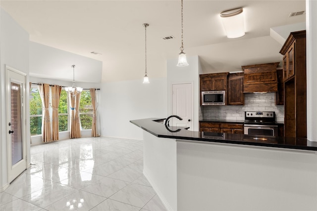 238 Rudder, Gun Barrel City, TX 75156 - kitchen featuring appliances with stainless steel finishes, dark countertops, decorative backsplash, a chandelier, and vaulted ceiling