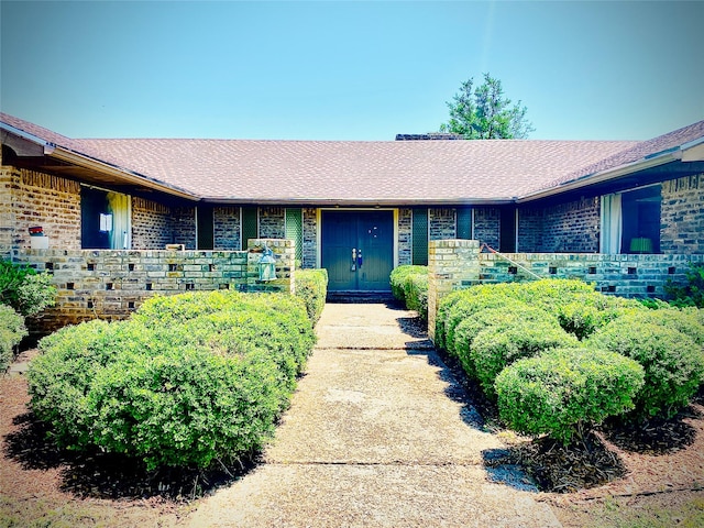 310 Lori Ln, Brownwood, TX 76801 - property entrance with brick siding and roof with shingles